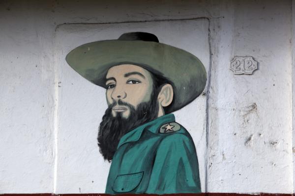 One of the Cuban revolutionary leaders Camilo Cienfuegos depicted in a hand painted sign on an apartment building in Havana, Cuba — No identificado