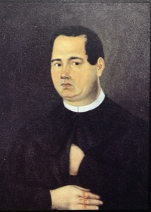 Retrato de un clérigo en túnica negra y cuello blanco — Hermenegildo Bustos