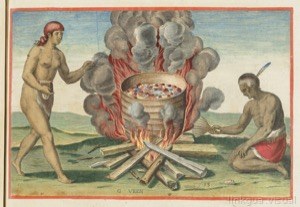 Indígenas cocinando alrededor de una gran fogata